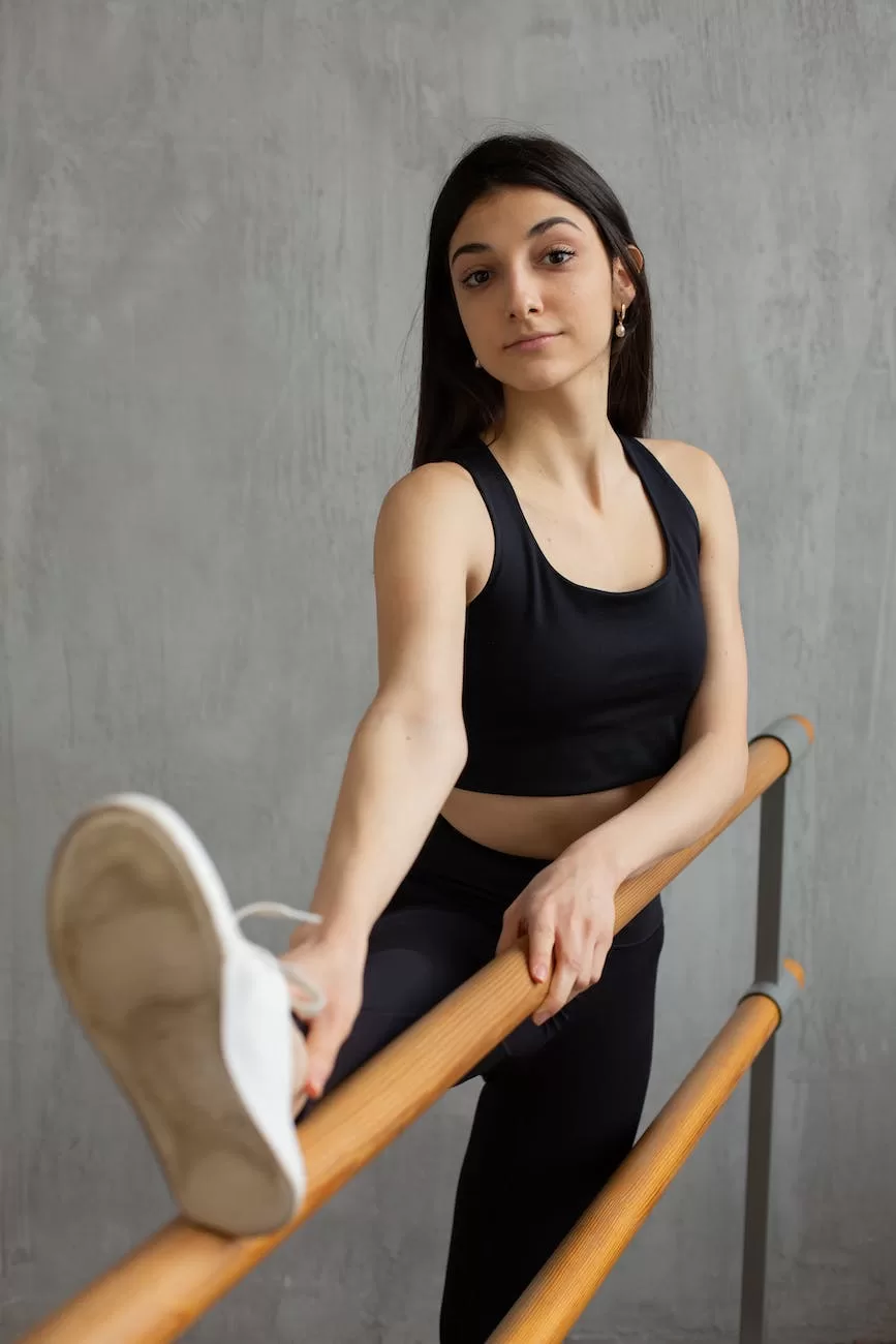 slim woman stretching legs in ballet studio