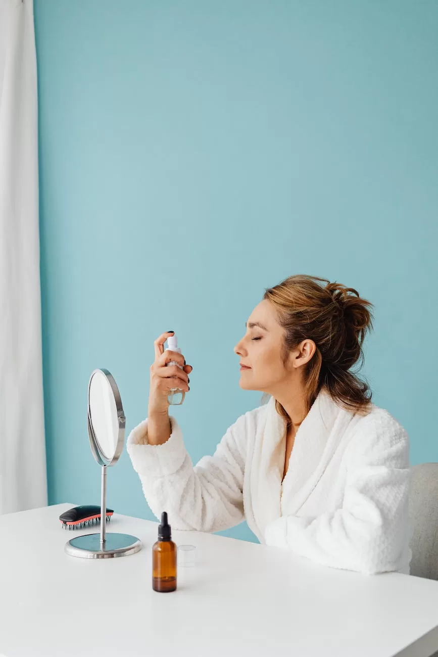 woman spraying face with setting spray